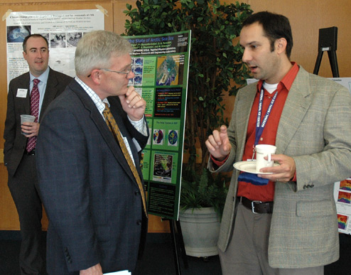 photo of Symposium attendees discussing the posters, June 9, 2009.