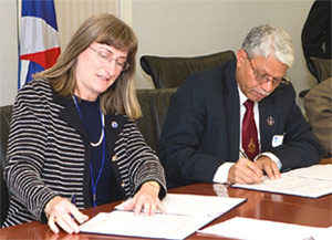 photo: Mary Kicza & Dr. Ajit Tyagi of MoES sign the INSAT-3D Satellite Data Agreement