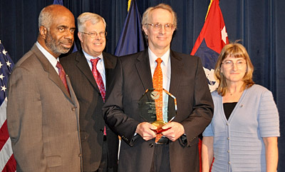 Bruce Ramsay receives his Distinguished Career Award from Assistant Administrator Dr. Larry Robinson; Charlie Baker, left and Mary Kicza at right