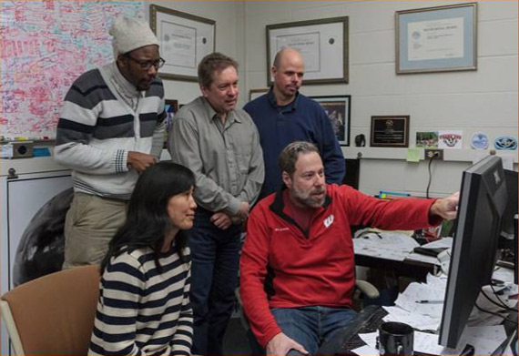 Tim Schmit (red shirt, hand on monitor) from the Advanced Satellite Products Branch with scientists from the Cooperative Institute for Meteorological Satellite Studies