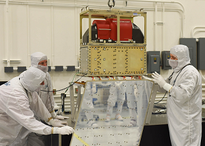 Ball Aerospace technicians lower the ATMS instrument onto the JPSS-1 spacecraft. Credit: Ball Aerospace & Technologies Corp..